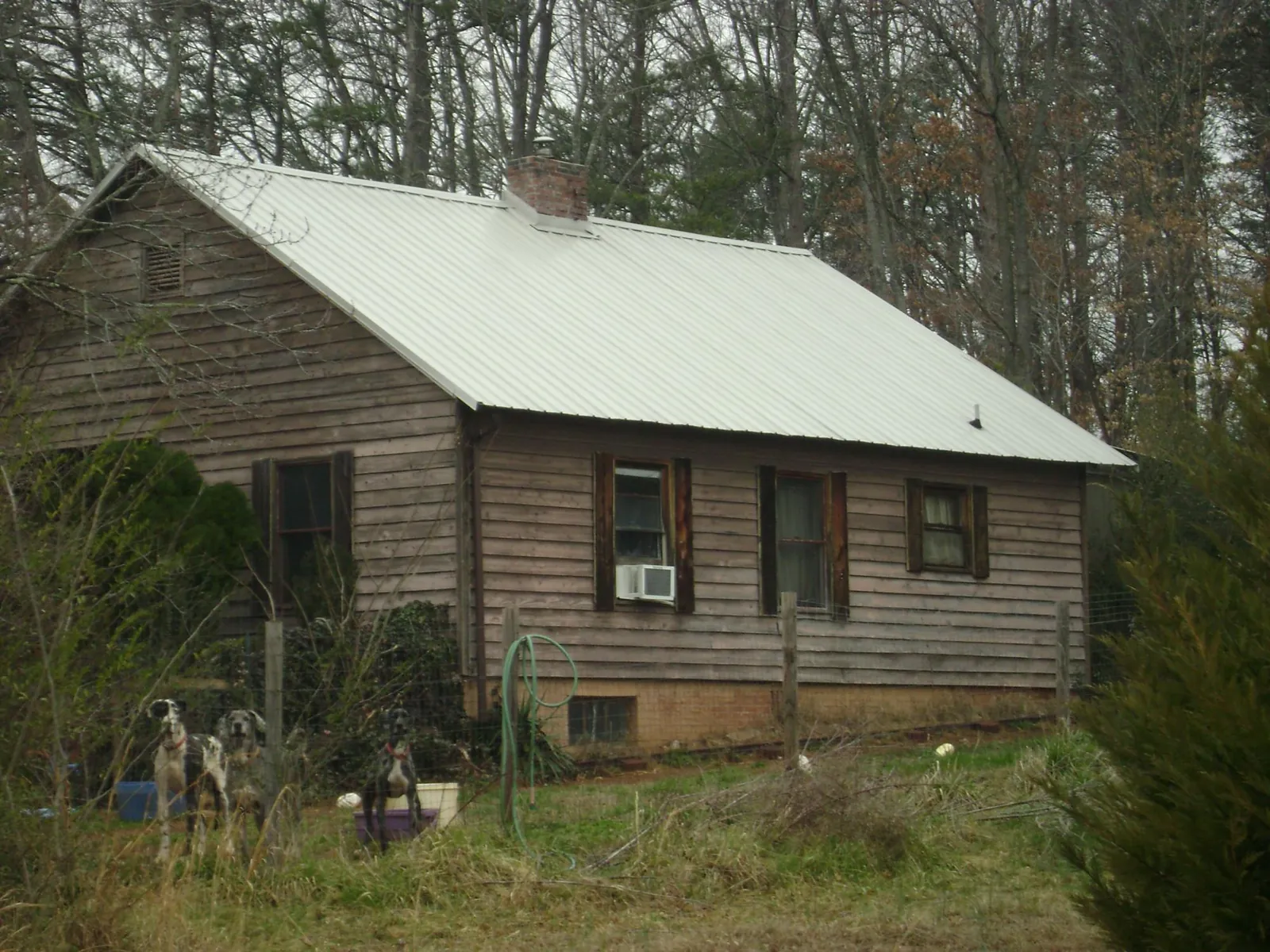 White metal roof on an old wood sided farmhouse, from a Metal Roof Installation job in Tiverton